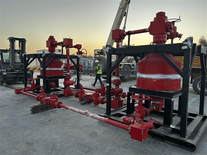 Skid-mounted spherical separators with flow iron at a wellsite at sunset